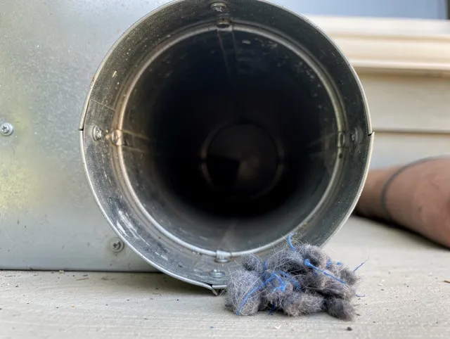 Ashland Dryer Vent Cleaning technician using specialized equipment to clear severe dryer vent blockage in Ashland
